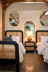 8. "Elegant Cane Oval Two Drawer Night Stand with natural cane detailing"