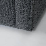 The Evita Swivel Chair in slate grey boucle. Its low profile makes it ideal for placement in a bedroom corner, a cozy reading nook, or as the perfect complement to your living room seating. Crafted in Europe and upholstered in a luxe boucle fabric, this barrel chair not only exudes sophistication but also boasts a hidden swivel base, allowing for subtle rotations around the room. Experience both style and functionality with this chic swivel chair designed to elevate the ambiance of any space in your home.