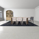 11. Oyster linen upholstered cane dining chair supported by a black frame