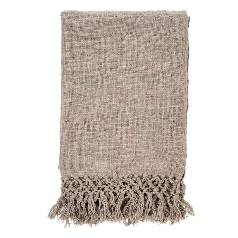 The Braided Tassel Throw is made of woven slub cotton lending an appealing texture that perfectly complements the intricate layering of hand knotted tassels on each end. Drape it decoratively over the arm of your sofa or accent chair as a dimensional layer. natural taupey colour