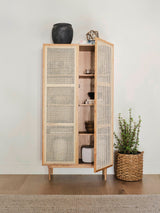 8. Cane bookcase featuring full doors for organized storage