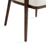 A fresh take on the traditional accent chair with soft ivory linen upholstered curves, Ash wood legs with walnut finish and  Polished gold trim