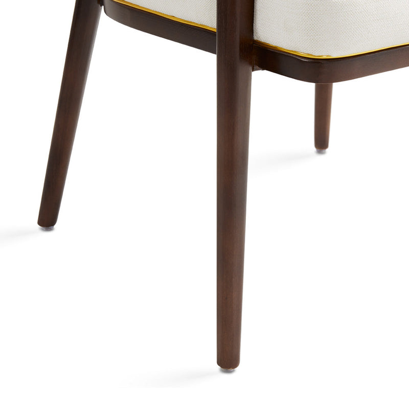 A fresh take on the traditional accent chair with soft ivory linen upholstered curves, Ash wood legs with walnut finish and  Polished gold trim