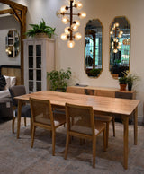 9. Elegant cane dining chair featuring oyster linen upholstery and natural frame
