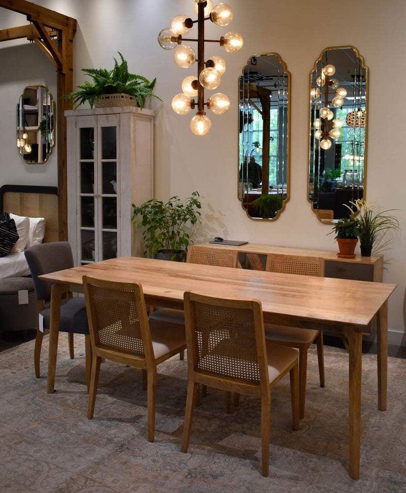 9. Elegant cane dining chair featuring oyster linen upholstery and natural frame