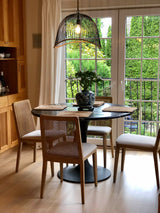 11. Cane dining chair in oyster linen and natural frame for a chic dining experience