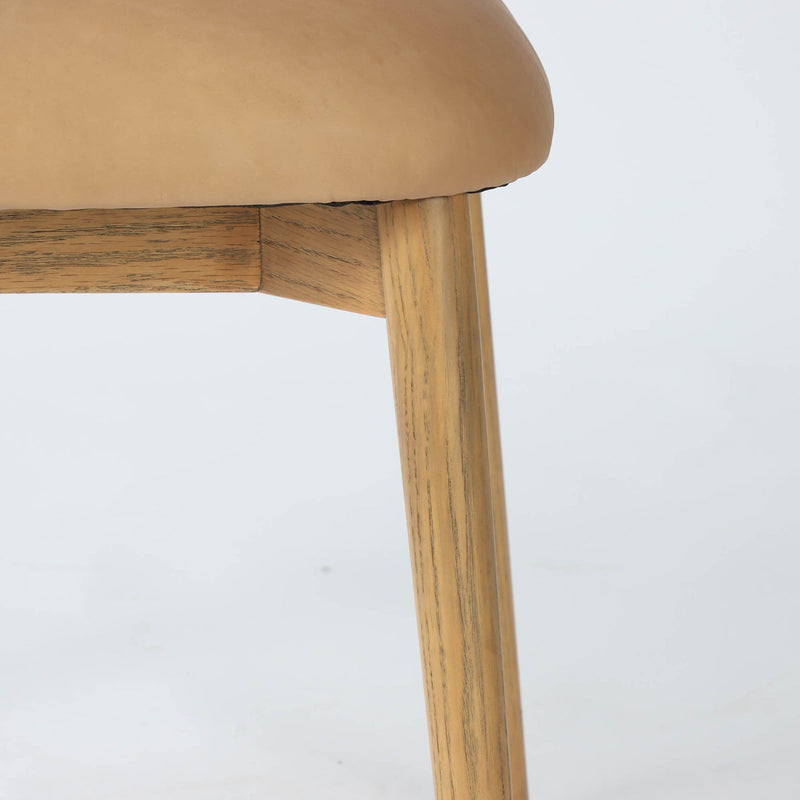 7. "Milo Dining Chair - Tan Leather with easy-to-clean upholstery and timeless appeal"