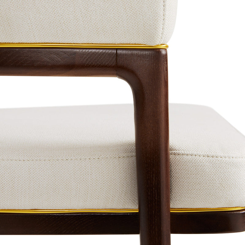 A fresh take on the traditional accent chair with soft ivory linen upholstered curves, Ash wood legs with walnut finish and  Polished gold trim